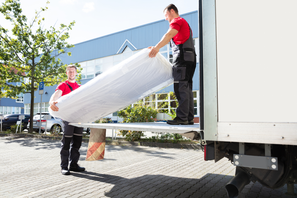 Movers loading collectible into truck when moving long distance